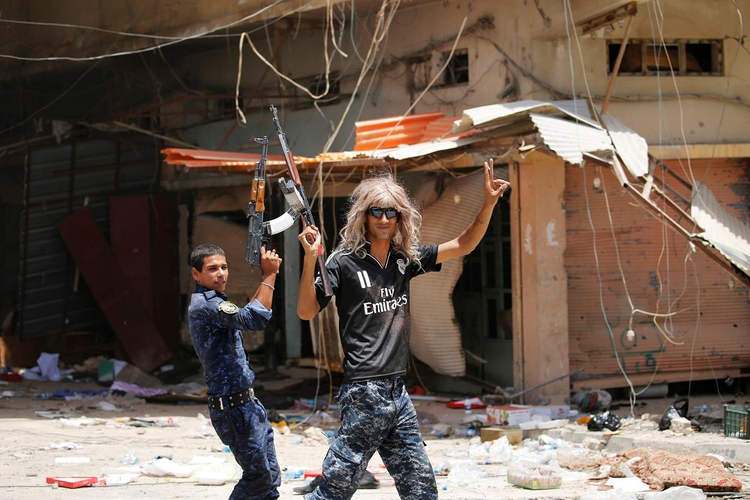 a member of iraqi government forces celebrate along a street in falluja after government forces recaptured the city from islamic state militants photo reuters