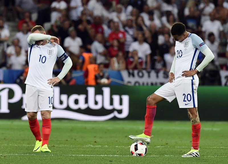 wayne rooney reacts as dele alli rests his foot on the ball photo afp