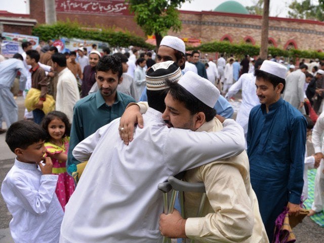 people exchange eid greetings after offering eidul fitr prayers in islamabad on july 29 2014 photo afp