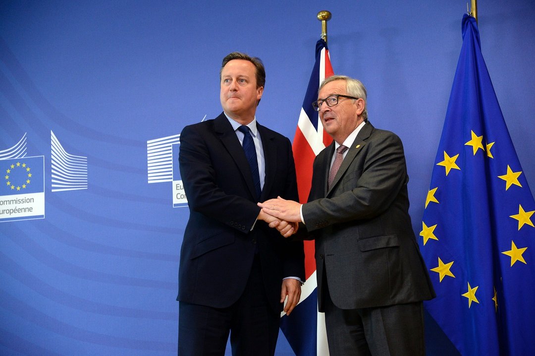 british prime minister david cameron l shakes hands with european union commission president jean claude juncker r photo afp