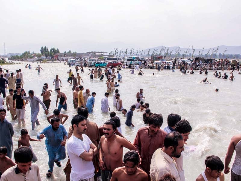 people gather at swat river photo express
