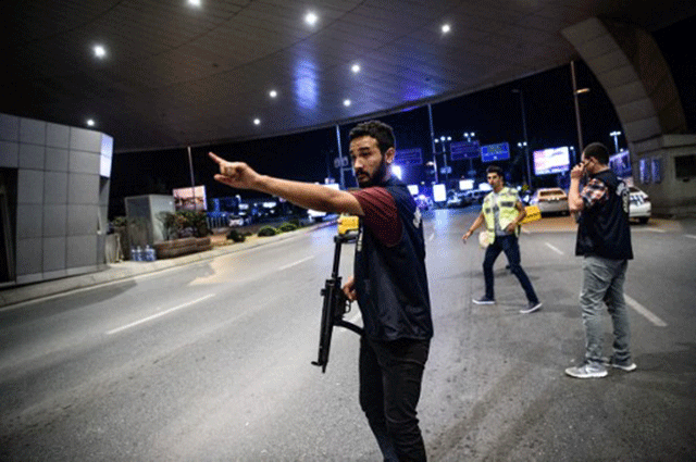 a turkish police officer reacts at ataturk airport s main gate on june 28 2016 in istanbul after two explosions followed by gunfire hit turkey s biggest airport killing at least 41 people and injuring several others photo afp