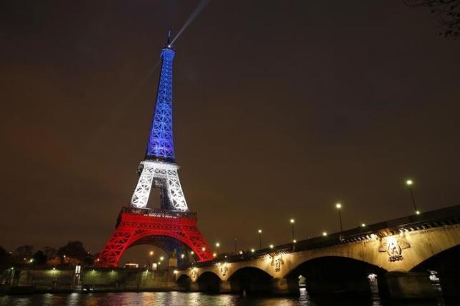 the eiffel tower is lit with the blue white and red colours of the french flag in paris to pay tribute to the victims of a series of deadly attacks in the french capital photo file