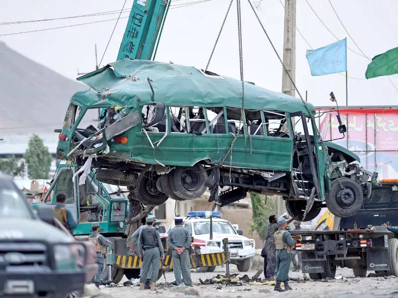 afghan policemen look on as the wreckage of a bus is removed from the site of a suicide bomb attack that targeted a convoy of buses transporting police cadets on the outskirts of kabul on thursday photo afp afghan policemen look on as the wreckage of a bus is removed from the site of a suicide bomb attack that targeted a convoy of buses transporting police cadets on the outskirts of kabul on thursday photo afp