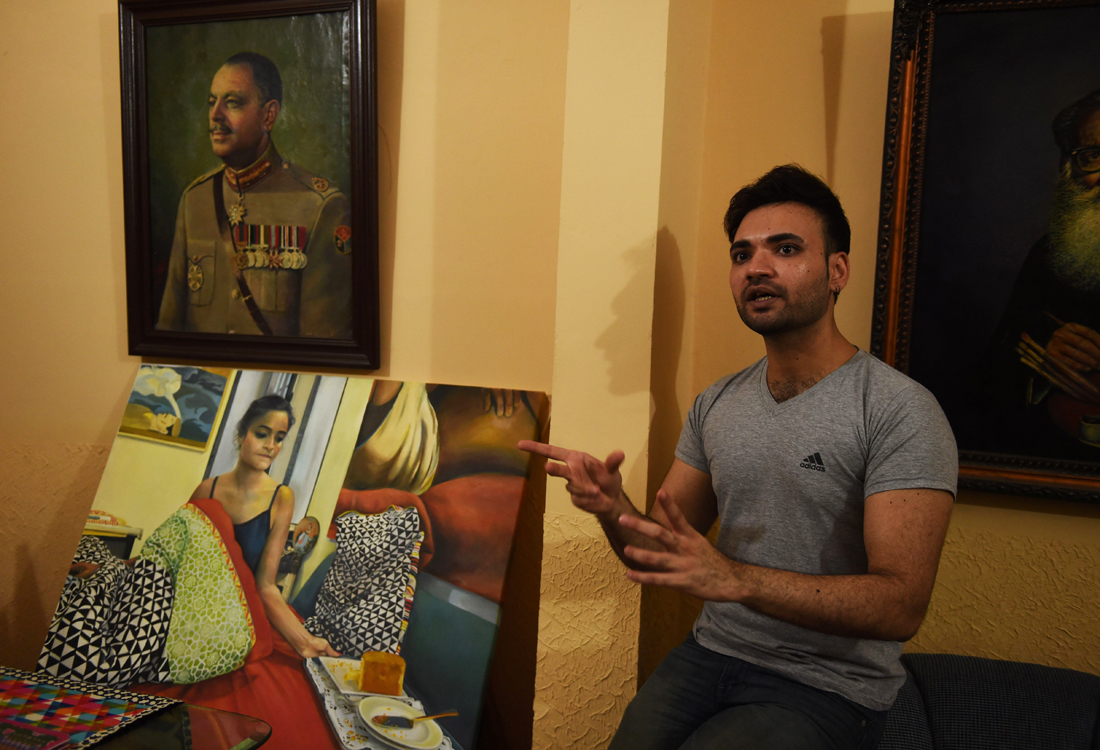 in this photograph taken on may 4 2016 mohammad ali a young pakistani artist shows his paintings at his studio in karachi photo afp