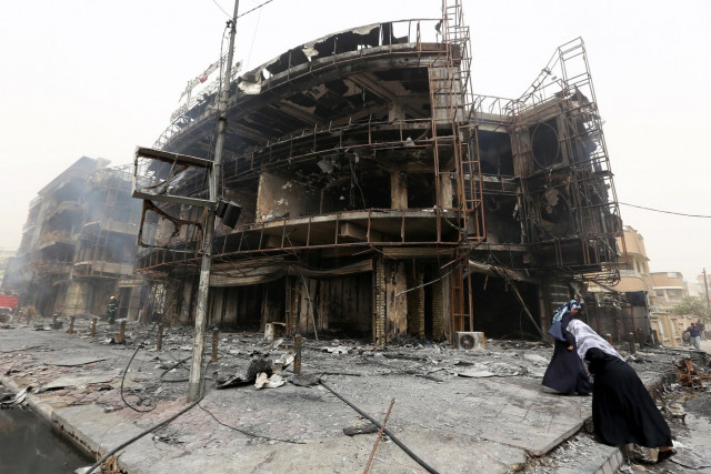 iraqi women walk past a damaged building at the site of a suicide car bombing claimed by the islamic state group on july 3 2016 in baghdad 039 s central karrada district photo afp iraqi women walk past a damaged building at the site of a suicide car bombing claimed by the islamic state group on july 3 2016 in baghdad 039 s central karrada district photo afp