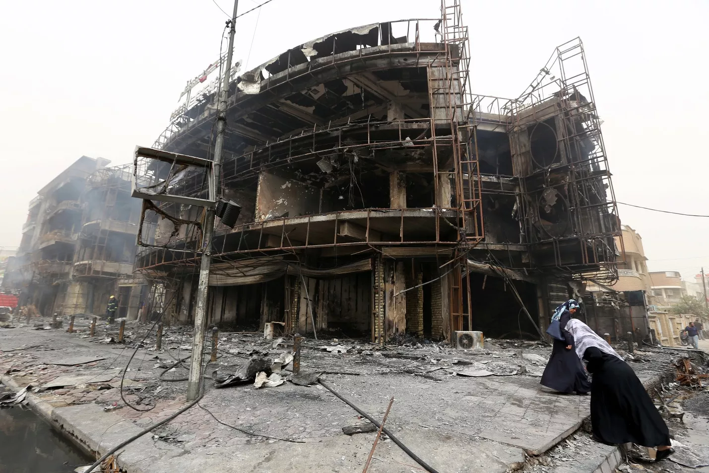 iraqi women walk past a damaged building at the site of a suicide car bombing claimed by the islamic state group on july 3 2016 in baghdad 039 s central karrada district photo afp iraqi women walk past a damaged building at the site of a suicide car bombing claimed by the islamic state group on july 3 2016 in baghdad 039 s central karrada district photo afp