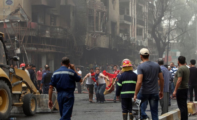iraqis evacuate a body from the site of a suicide car bombing claimed by the islamic state group on july 3 2016 in baghdad 039 s central karrada district photo afp