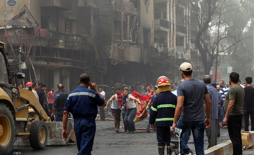 iraqis evacuate a body from the site of a suicide car bombing claimed by the islamic state group on july 3 2016 in baghdad 039 s central karrada district photo afp