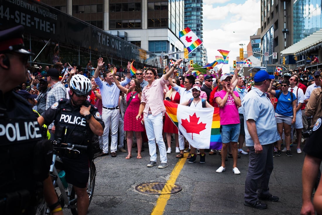 canadian prime minister justin trudeau middle waving flag participates at the annual pride festival parade july 3 2016 in toronto ontario canada photo afp