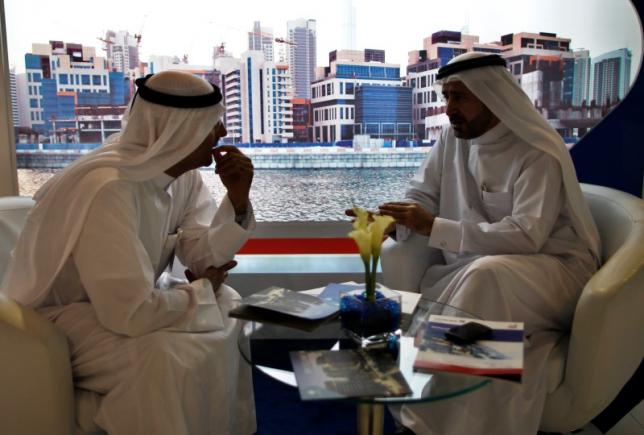 file photo   businessmen speak to each other during the cityscape real estate exhibition in dubai october 2 2012 photo reuters