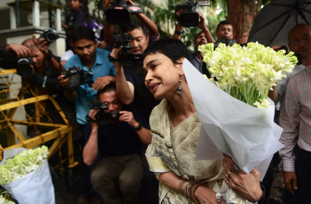 a woman speaks before leaving a floral arrangement at a road block leading to an upscale cafe that was the scene of a bloody attack in the bangaldesh capital dhaka on july 16 2016 photo afp a woman speaks before leaving a floral arrangement at a road block leading to an upscale cafe that was the scene of a bloody attack in the bangaldesh capital dhaka on july 16 2016 photo afp