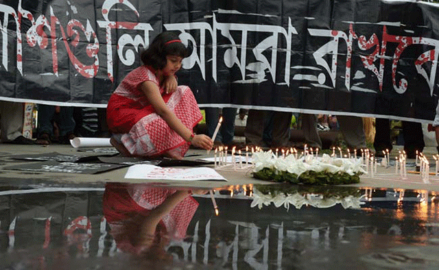 people light candles at a memorial for the victims of dhaka attack photo afp people light candles at a memorial for the victims of dhaka attack photo afp