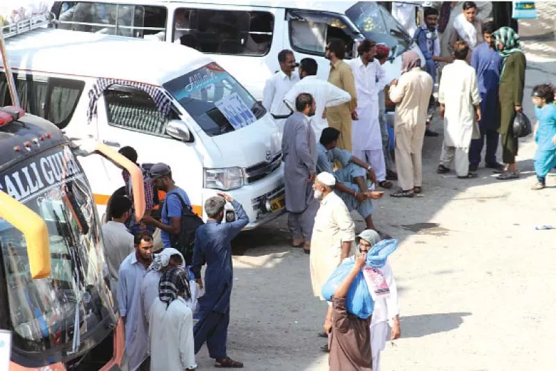 passengers wait for buses at a bus stand in islamabad photo muhammad javaid express passengers wait for buses at a bus stand in islamabad photo muhammad javaid express