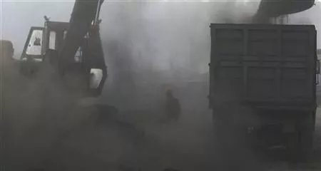 a man is shrouded in coal dust as a bulldozer loads coal onto a truck at a railway yard photo reuters a man is shrouded in coal dust as a bulldozer loads coal onto a truck at a railway yard photo reuters