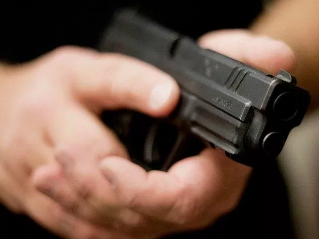 a man is pictured holding a hand gun photo reuters a man is pictured holding a hand gun photo reuters