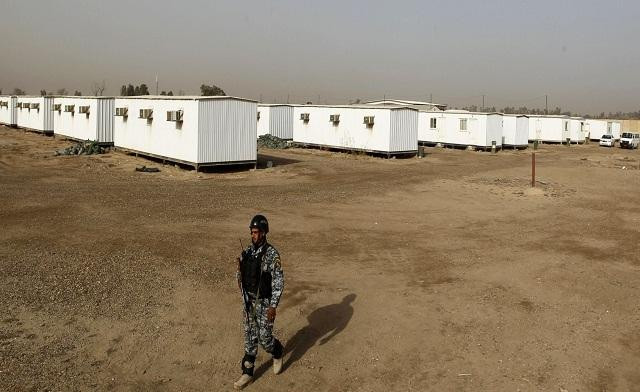 an iraqi soldier stands guard in the former u s military camp liberty which will be the new temporary camp for the iranian exile group the mujahideen khalq organization in baghdad photo reuters an iraqi soldier stands guard in the former u s military camp liberty which will be the new temporary camp for the iranian exile group the mujahideen khalq organization in baghdad photo reuters