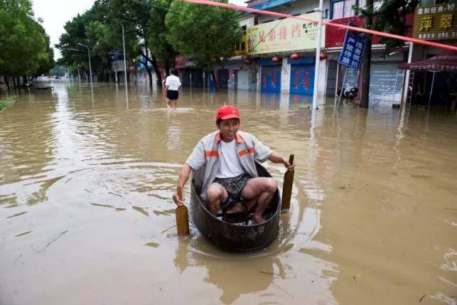 a resident rows a makeshift boat to make his way at a flooded street in chaohu anhui province china july 2 2016 photo reuters