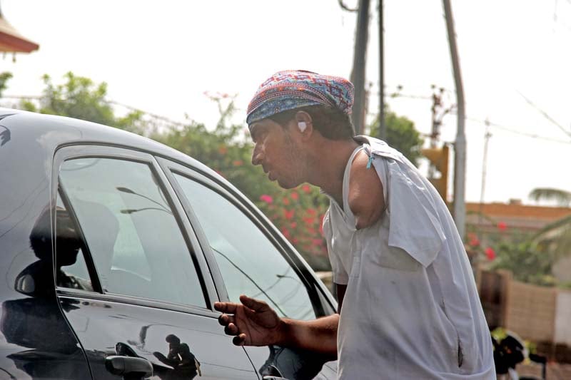 a physically handicapped man asking for alms at a traffic signal in dha photo ayesha mir express