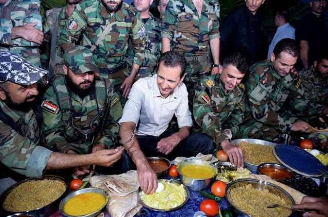 this file photo shows syrian president bashar al assad sharing iftar dinner with syrian soldiers photo afp this file photo shows syrian president bashar al assad sharing iftar dinner with syrian soldiers photo afp