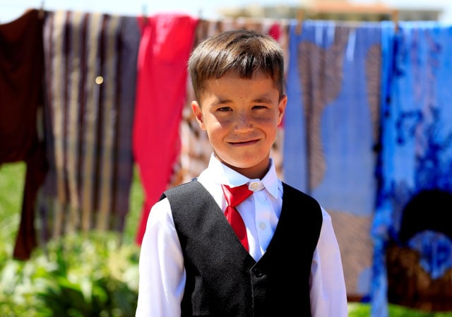 a syrian boy living in the refugee camp of delhemiyeh village poses in new clothes as he celebrates eidul fitr july 6 2016 photo reuters jamal saidi