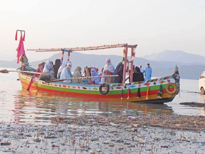 people take a boat nele on a boat in tarbela dam photo muhammad sadaqat express