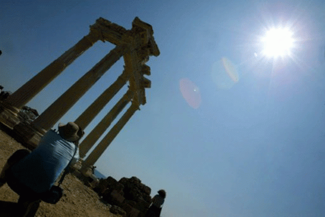 a tourist takes a picture of the temple of apollo near the turkish resort of antalya photo afp a tourist takes a picture of the temple of apollo near the turkish resort of antalya photo afp