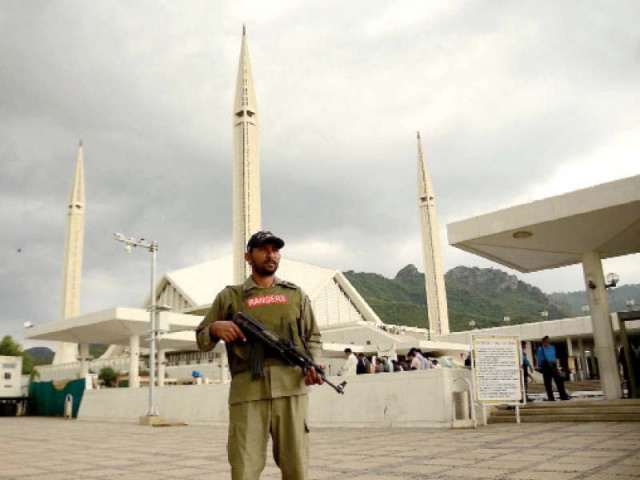 a police official provides security outside faisal mosque in islamabad photo file a police official provides security outside faisal mosque in islamabad photo file