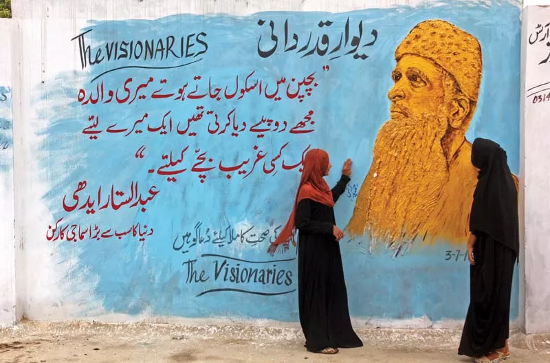 girls walk by a mural painted by artist hameedullah on a portion of the boundary wall of memon technical amp industrial institute miti in karachi s korangi neighbourhood to pay tribute to abdul sattar edhi the project of welfare organisation is behind the initiative in collaboration with miti photo athar khan express girls walk by a mural painted by artist hameedullah on a portion of the boundary wall of memon technical amp industrial institute miti in karachi s korangi neighbourhood to pay tribute to abdul sattar edhi the project of welfare organisation is behind the initiative in collaboration with miti photo athar khan express
