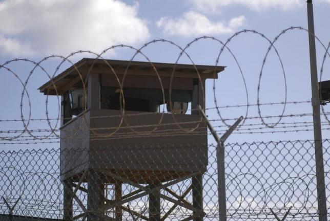 a soldier stands guard in a tower overlooking camp delta at guantanamo bay naval base in a december 31 2009 file photo provided by the us navy photo reuters us navy