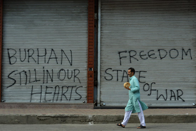 a kashmiri muslim man walks past closed shops during a curfew in srinagar on july 11 2016 more than twenty protesters were killed and 200 others injured in disputed indian administered kashmir on july 9 after thousands defied a curfew following the death of a top rebel commander burhan muzaffar wani officials said afp photo a kashmiri muslim man walks past closed shops during a curfew in srinagar on july 11 2016 more than twenty protesters were killed and 200 others injured in disputed indian administered kashmir on july 9 after thousands defied a curfew following the death of a top rebel commander burhan muzaffar wani officials said afp photo