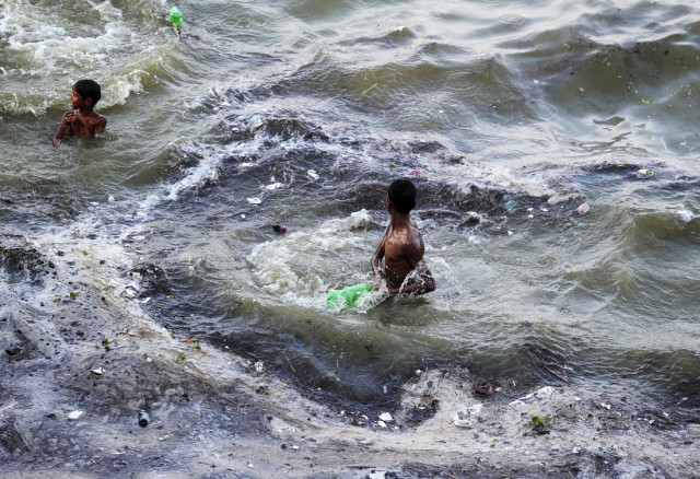 indian youths play in flood waters after the level of the river ganges rose following heavy monsoon rains in allahabad on july 10 2016 afp photo