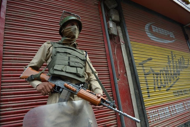 an indian paramilitary trooper stands guard on a street during a curfew in srinagar on july 11 2016 photo afp an indian paramilitary trooper stands guard on a street during a curfew in srinagar on july 11 2016 photo afp