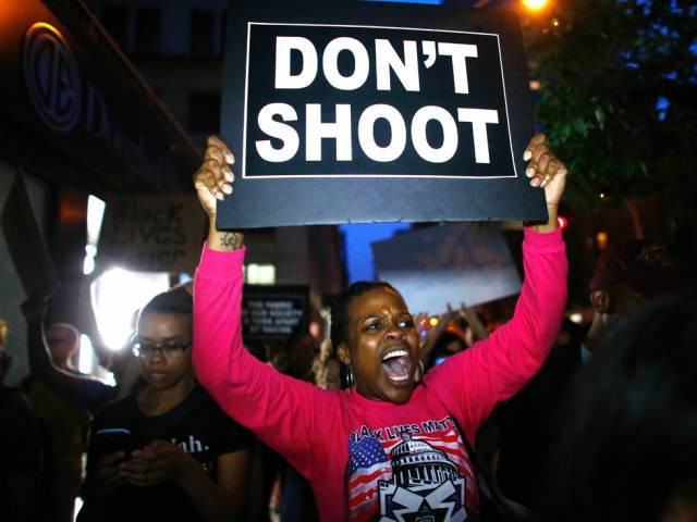 a woman holds a banner during a protest in support of the black lives matter movement in new york on july 09 2016 photo afp a woman holds a banner during a protest in support of the black lives matter movement in new york on july 09 2016 photo afp