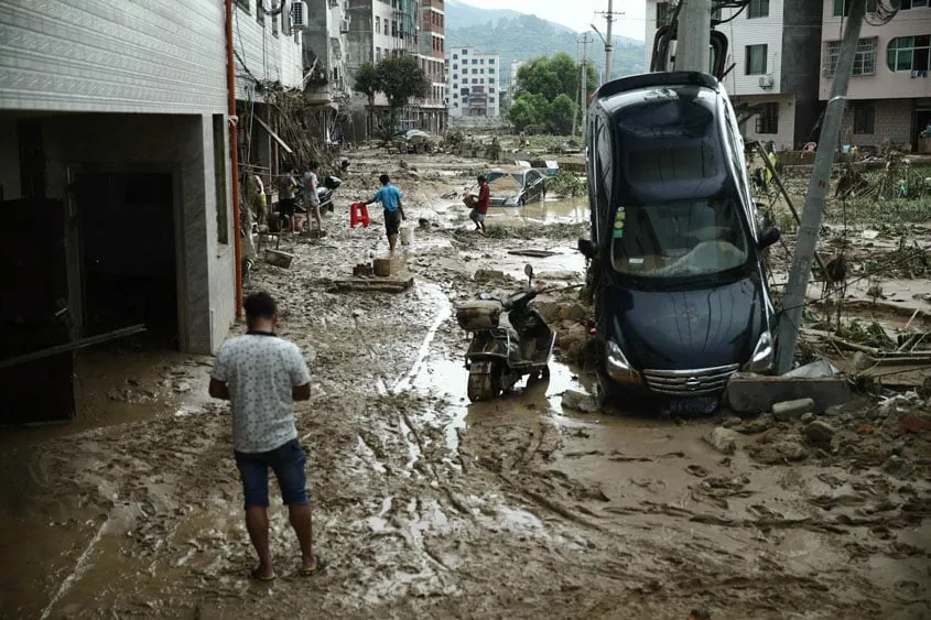 this photo taken on july 10 2016 shows residents walking past a damaged car in the aftermath of a tropical storm in bandong town in minqing county east china 039 s fujian province photo afp this photo taken on july 10 2016 shows residents walking past a damaged car in the aftermath of a tropical storm in bandong town in minqing county east china 039 s fujian province photo afp