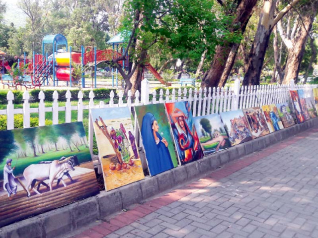 richly coloured the paintings are displayed along a footpath near kohsar market photo shazia mehboob express richly coloured the paintings are displayed along a footpath near kohsar market photo shazia mehboob express