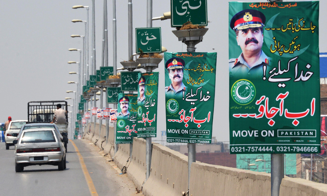 pakistani commuters drive past posters of army chief general raheel sharif in peshawar on july 12 2016 photo afp