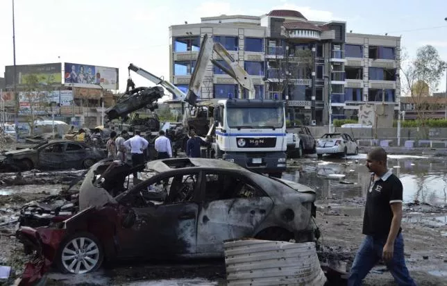 iraqi security forces and civilians gather at the site of a car bomb attack in baghdad october 21 2014 photo reuters