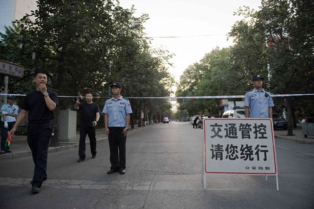 chinese police officers block the road leading to the philippines embassy in beijing on july 12 2016 photo afp