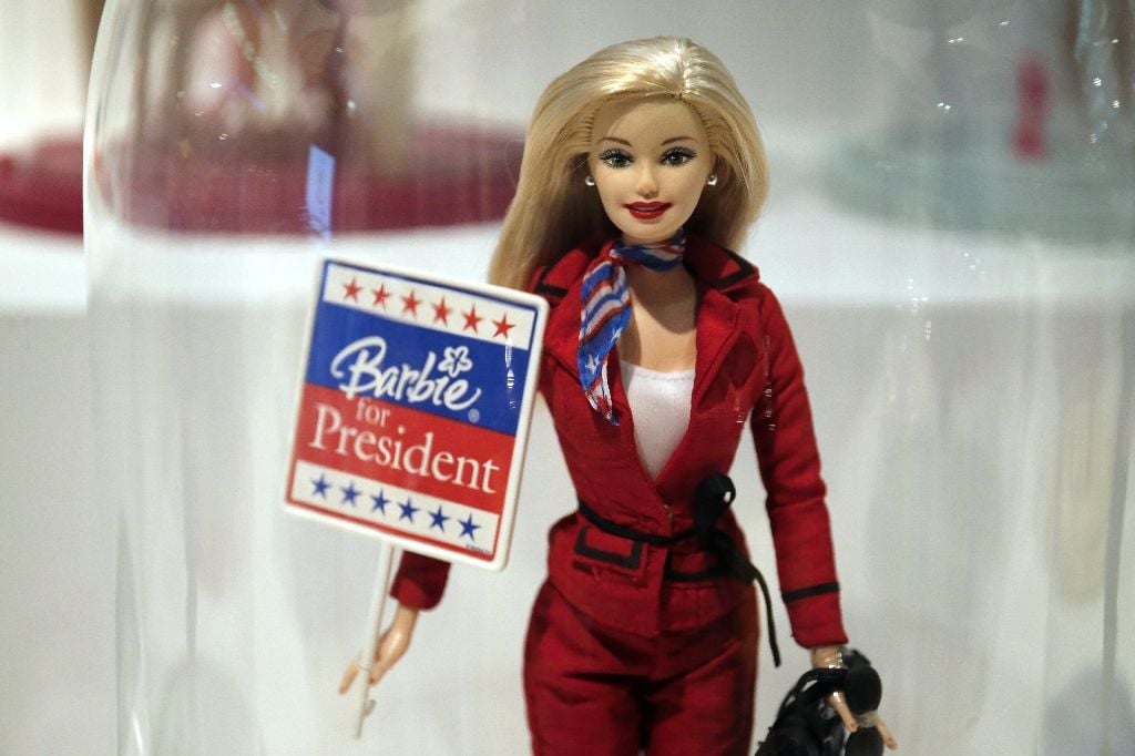 a doll holding an electoral poster reading quot barbie for president quot on display at the quot barbie life of an icon quot exhibition at the museum of decorative arts in paris photo afp