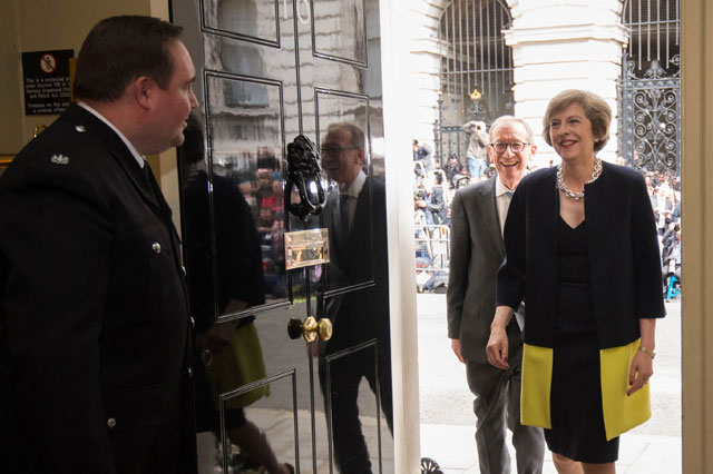 new british prime minister theresa may r and her husband philip john 2r walk into 10 downing street in london on july 13 2016 after meeting queen elizabeth ii and accepting her invitation to become prime minister and form a new government photo afp