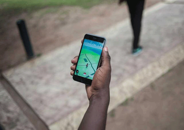 a picture taken on july 14 2016 shows an avatar on the screen of a mobile phone as a player uses the pokemon go application on his mobile on the campus grounds of the university of lagos photo afp a picture taken on july 14 2016 shows an avatar on the screen of a mobile phone as a player uses the pokemon go application on his mobile on the campus grounds of the university of lagos photo afp