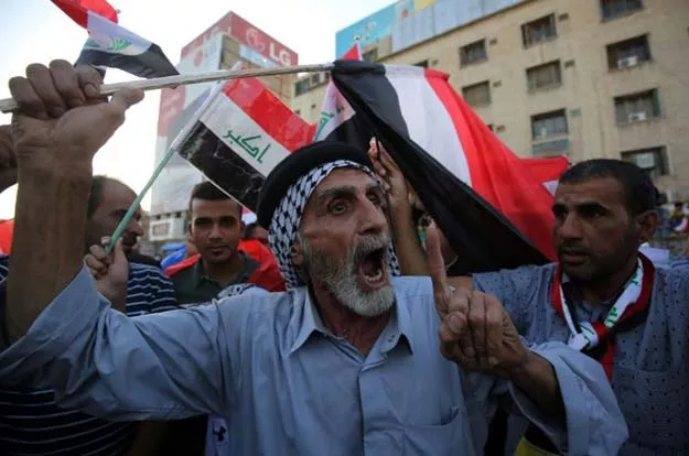 supporters of iraqi shia cleric moqtada al sadr wave the national flag during a demonstration in baghdad 039 s tahrir square on july 15 2016 photo afp supporters of iraqi shia cleric moqtada al sadr wave the national flag during a demonstration in baghdad 039 s tahrir square on july 15 2016 photo afp