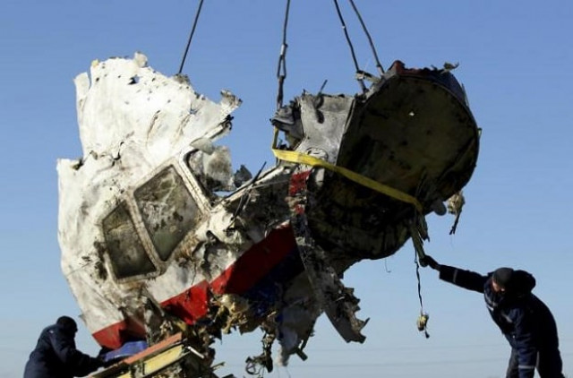 local workers transport a piece of the malaysia airlines flight mh17 wreckage at the site photo reuters local workers transport a piece of the malaysia airlines flight mh17 wreckage at the site photo reuters