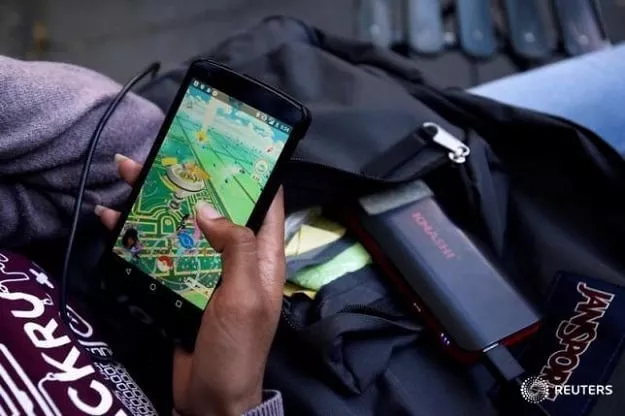 a woman uses a portable battery pack to charge her phone while playing the augmented reality mobile game quot pokemon go quot by nintendo photo reuters a woman uses a portable battery pack to charge her phone while playing the augmented reality mobile game quot pokemon go quot by nintendo photo reuters