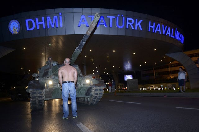 a man stands in front of a turkish army tank at ataturk airport in istanbul turkey july 16 2016 photo reuters