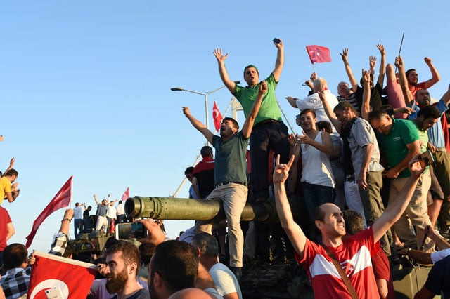 people rally on a tank after they take over military position on the bosphorus bridge in istanbul on july 16 2016 photo afp