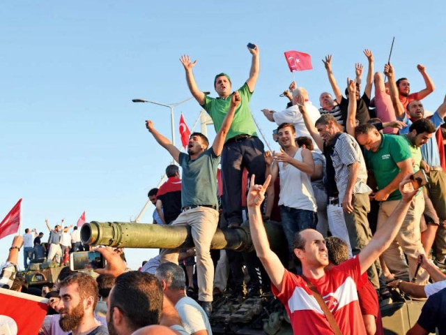 people rally on a tank after taking over a military position on the bosphorus bridge in istanbul photo afp people rally on a tank after taking over a military position on the bosphorus bridge in istanbul photo afp