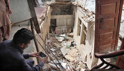 under the rubble two die as 80 year old building collapses