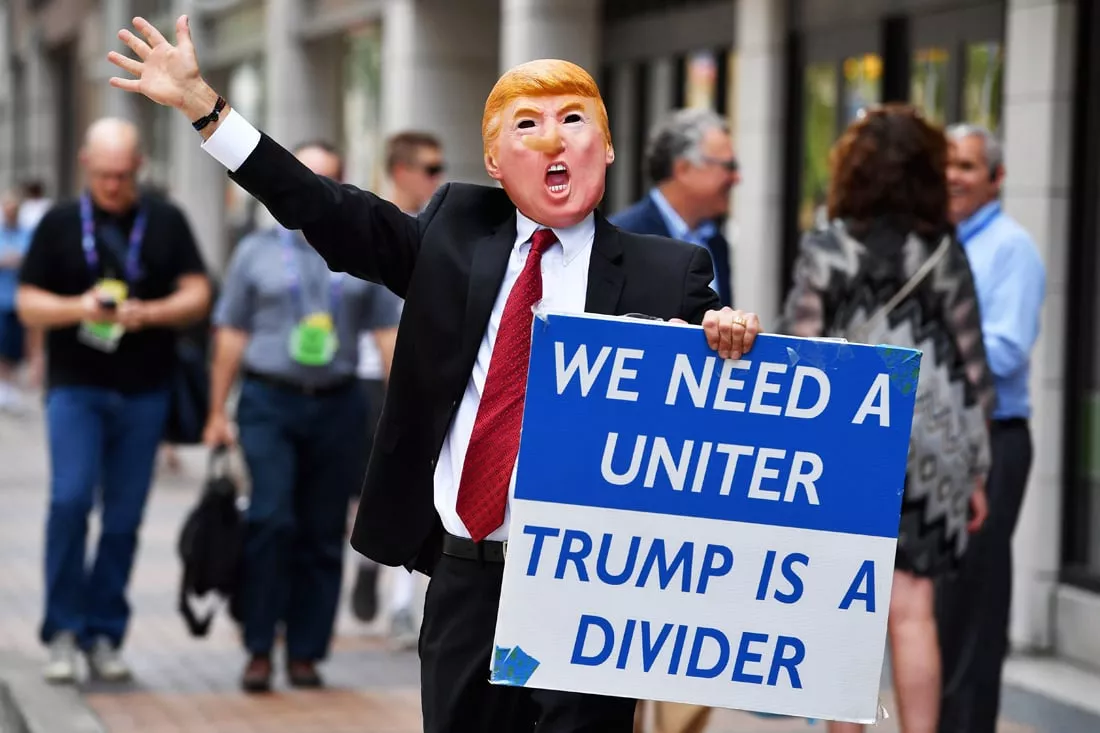 a man wearing a mask of donald trump walks through downtown ahead of the upcoming republican national convention on july 17 2016 in cleveland ohio photo afp a man wearing a mask of donald trump walks through downtown ahead of the upcoming republican national convention on july 17 2016 in cleveland ohio photo afp